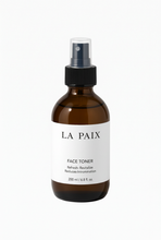 La Paix-tonerbottel reguit vorentoe op ’n skoon wit agtergrond